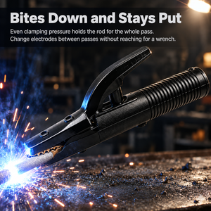 A black welding clamp held at the tip of a welding rod, with bright blue-white sparks and orange embers flying on a dark workbench. White marketing text at the top reads, 'Bites Down and Stays Put' with additional instructional copy about clamping pressure and changing electrodes.
